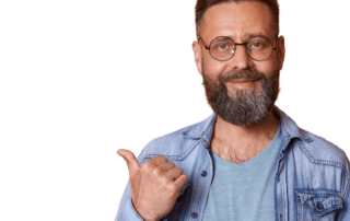A man with a bushy beard and round glasses pointing left with his thumb to the content